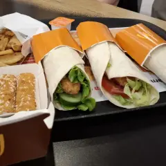 Trzy wrapy z kurczakiem i warzywami, frytki i nuggetsy. Czy wrap z mąki jest zdrowy? Zależy od składników i sposobu przygotowania.