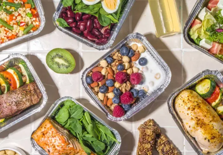 Różnorodne posiłki w pudełkach: łosoś, kurczak, sałatka, owsianka z owocami. Sprawdź, jakie są dieta pudełkowa koszty i wybierz zdrowy catering!