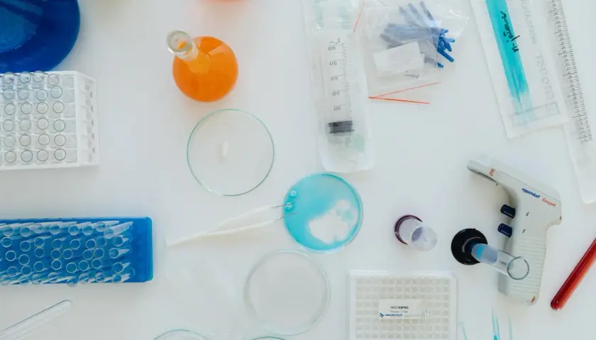 Laboratorium bada kawę i jej wpływ na histaminę. Widoczne probówki, pipety, płytki z oznaczeniem "HISTAMINE" i inne akcesoria laboratoryjne.